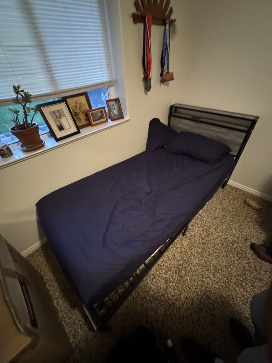 Twin XL bed with mattress topper and bed frame