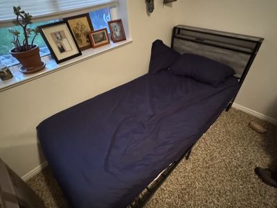Twin XL bed with mattress topper and bed frame