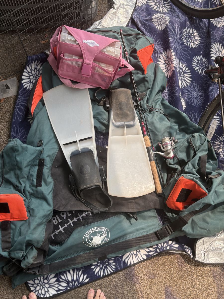 Inflatable float tube, flippers, fishing pole, and tackle box
