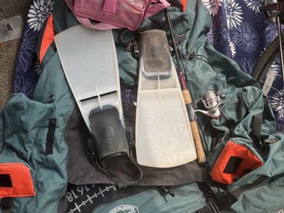 Inflatable float tube, flippers, fishing pole, and tackle box