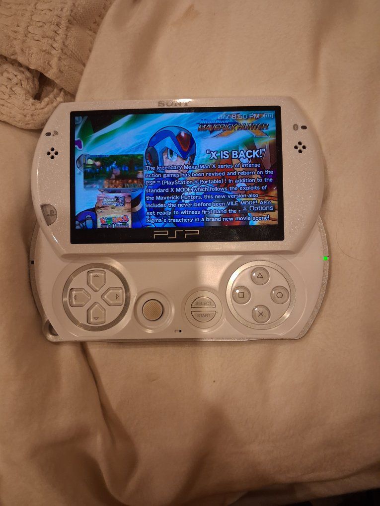 Pearl White PSPGo with a few downloaded games