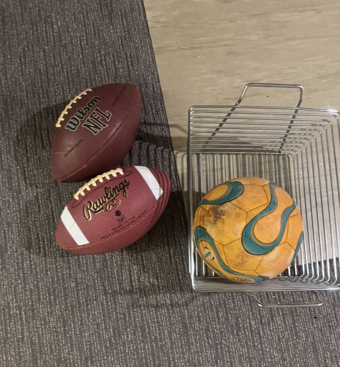 Lot of 3 Sports Balls: Wilson NFL Football, Rawlings Football, and Soccer Ball with Wire Basket