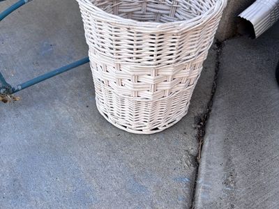 Darling white wicker trash can.