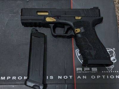Custom gold and black Glock.