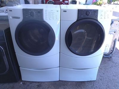 Kenmore Elite front load washer with matched electric dryer on pedestals