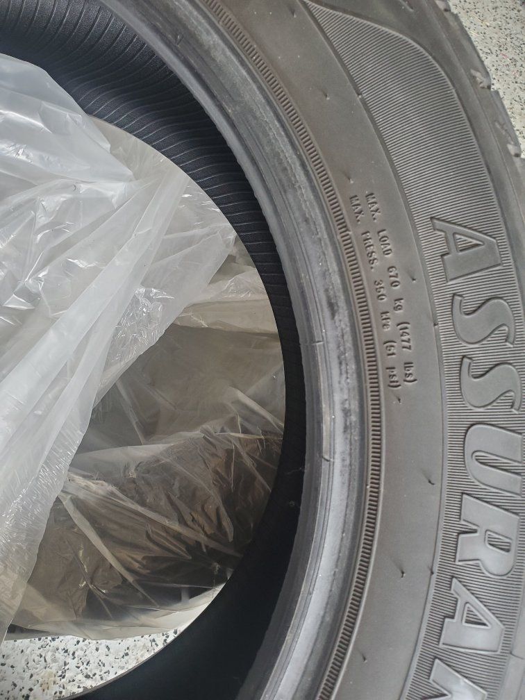 Two Goodyear Assurance Maxlife 215/55R17 94V all-season high mileage touring tires.