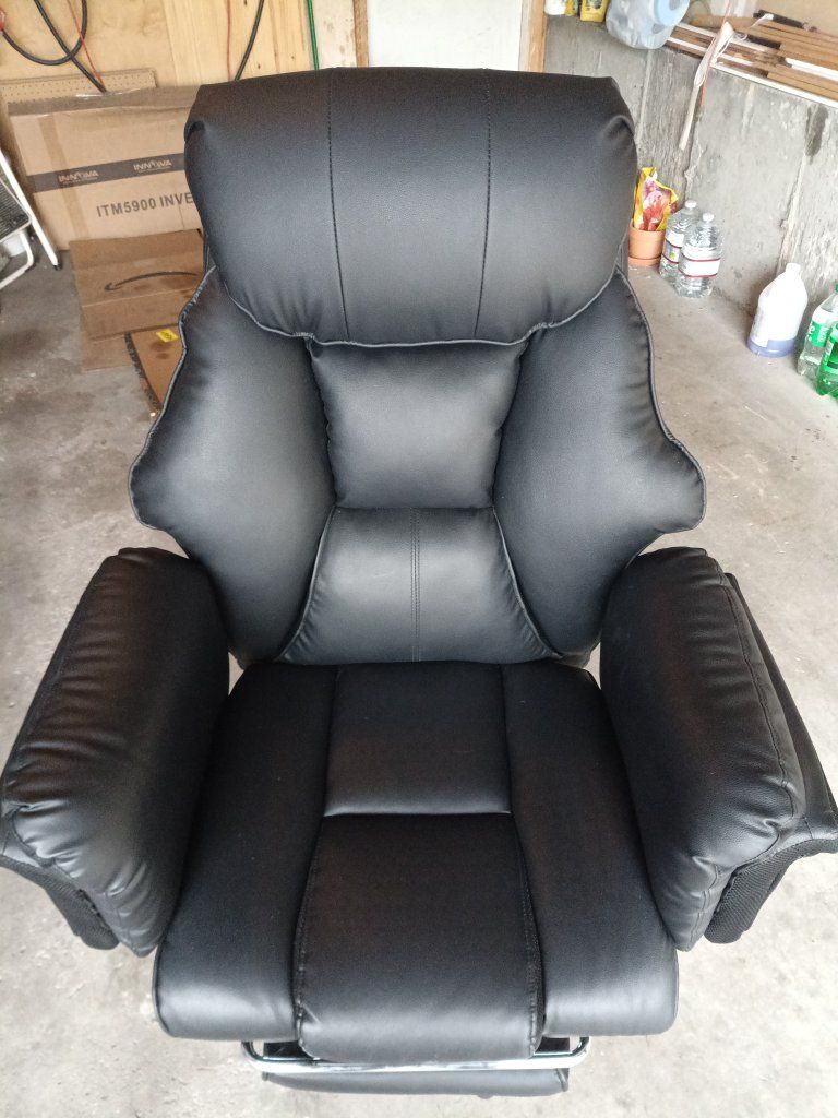 Barely used Black Faux Leather Executive Office Chair with Rolling Base and leg rest for reclining.