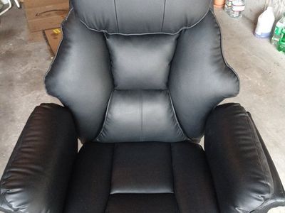 Barely used Black Faux Leather Executive Office Chair with Rolling Base and leg rest for reclining.
