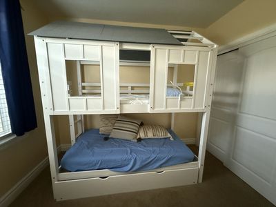 White Playhouse Twin Over Full Bunk Bed with Roof and trundle bed.