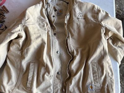 Carhartt woman coat and cabela’s hunting orange bibs underArmor sweatshirt
