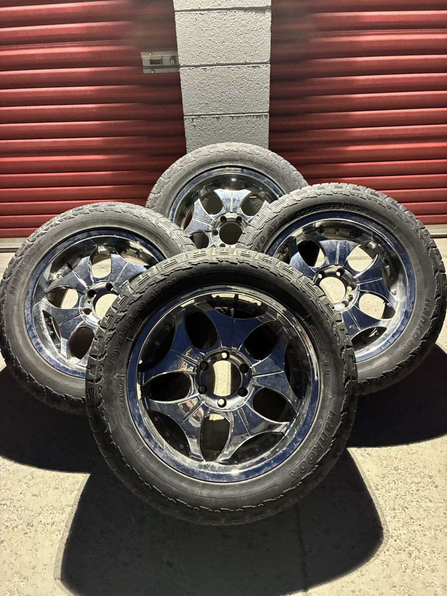 Set of 4 chrome wheels with tires mounted.