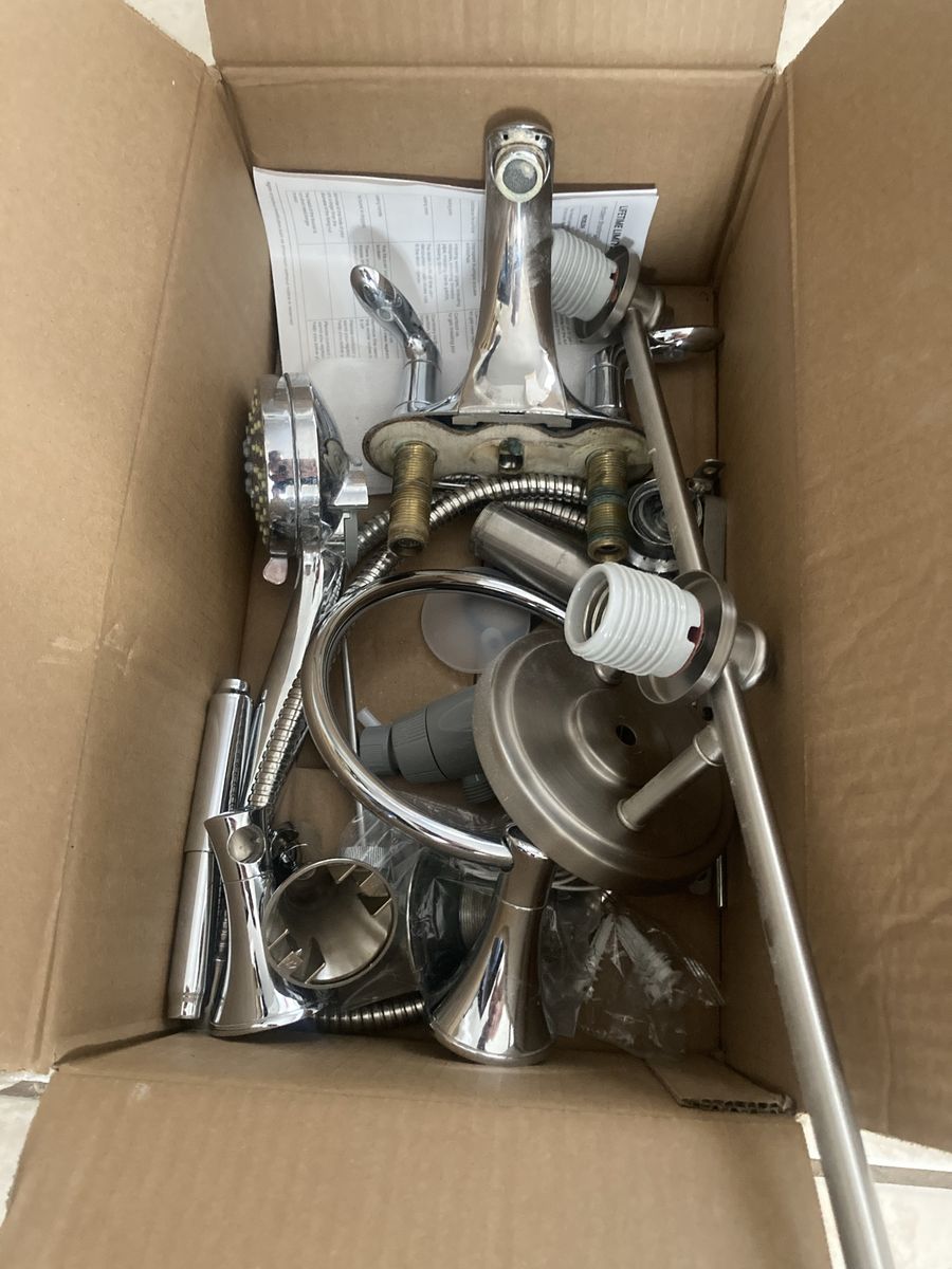 Box of bathroom fixtures and vanity mirror