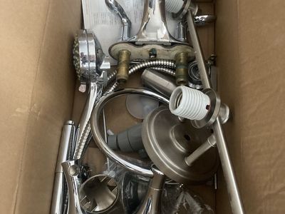 Box of bathroom fixtures and vanity mirror