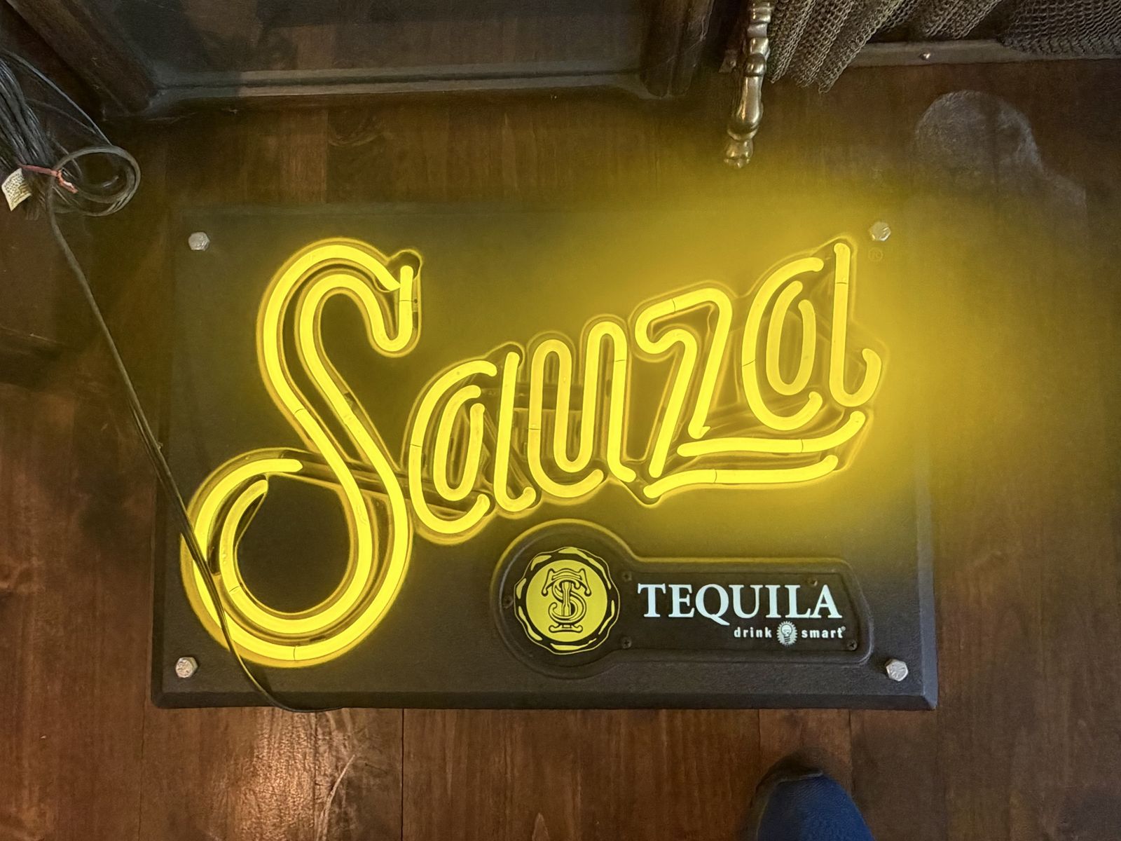 Sauza tequila neon sing with yellow lettering