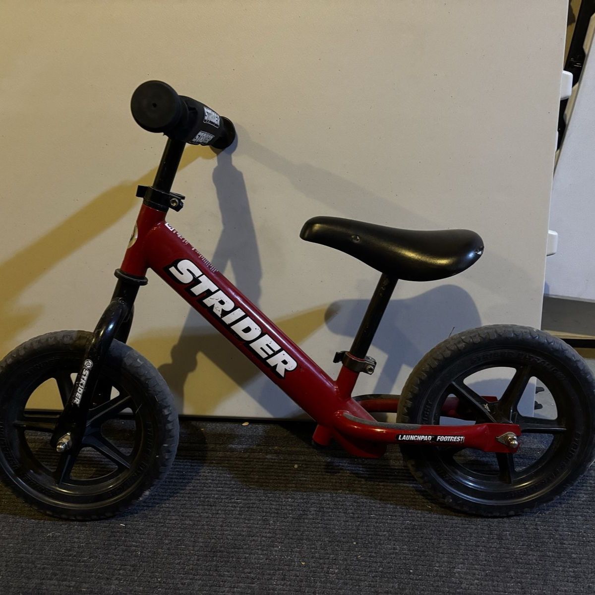Strider Bike for small children - Red Launchpad Footrest Kids Balance Bike - Used, Good Condition