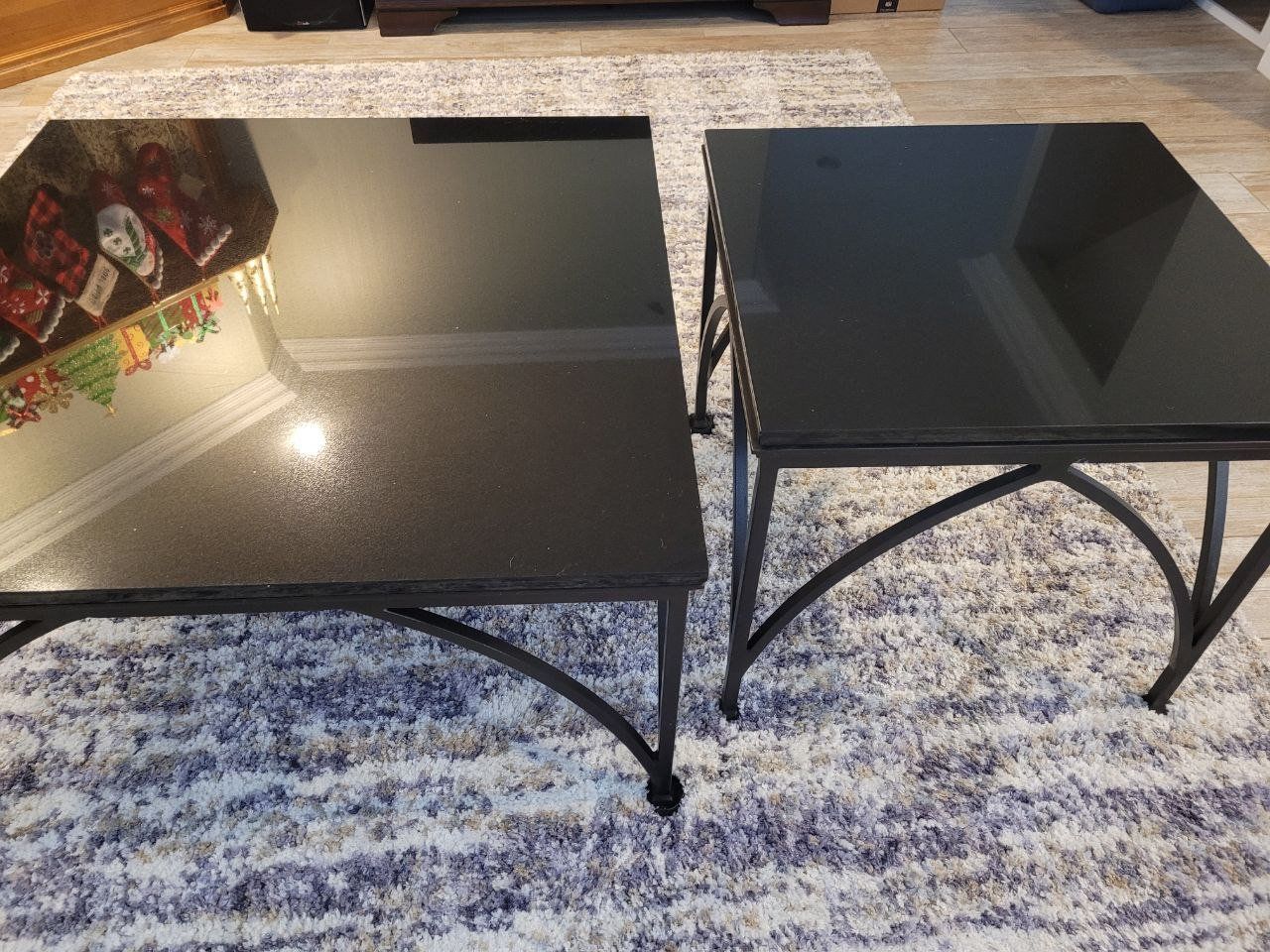Two black polished marble end tables