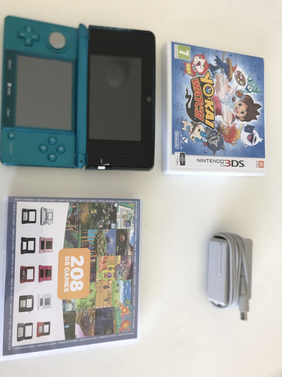 Nintendo 3ds, 208 ds games plus mods, yo Kai watch game, and charger.