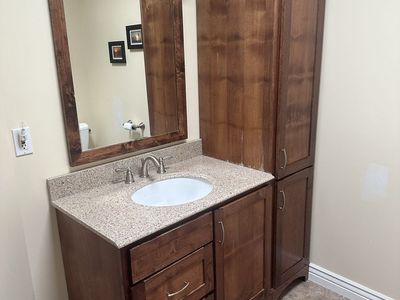 Alder bathroom vanity set with granite countertop, base cabinet, linen cabinet and mirror