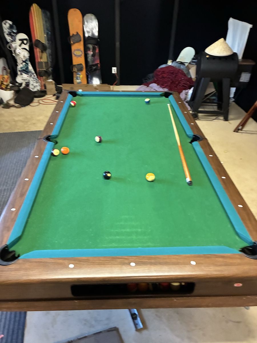 Pool table with balls and cues