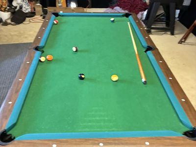 Pool table with balls and cues