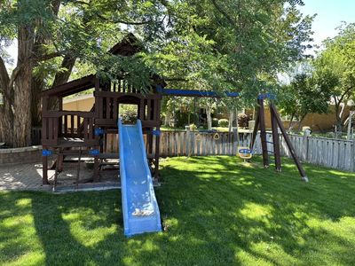 Three level Treehouse with climbing wall, slide, swings, monkey bars and Picnic table with benches.