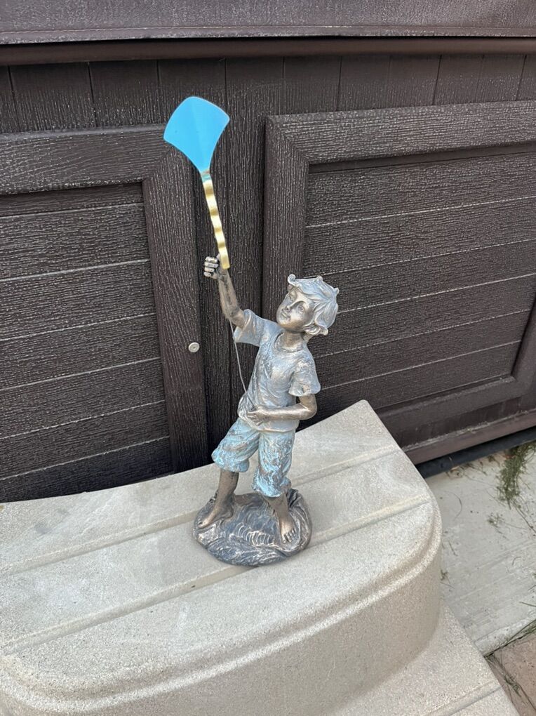 Resin boy holding kite statue 22” tall