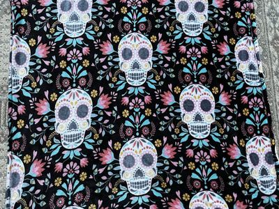soft throw blanket features a vibrant, repeating pattern of colorful Day of the Dead