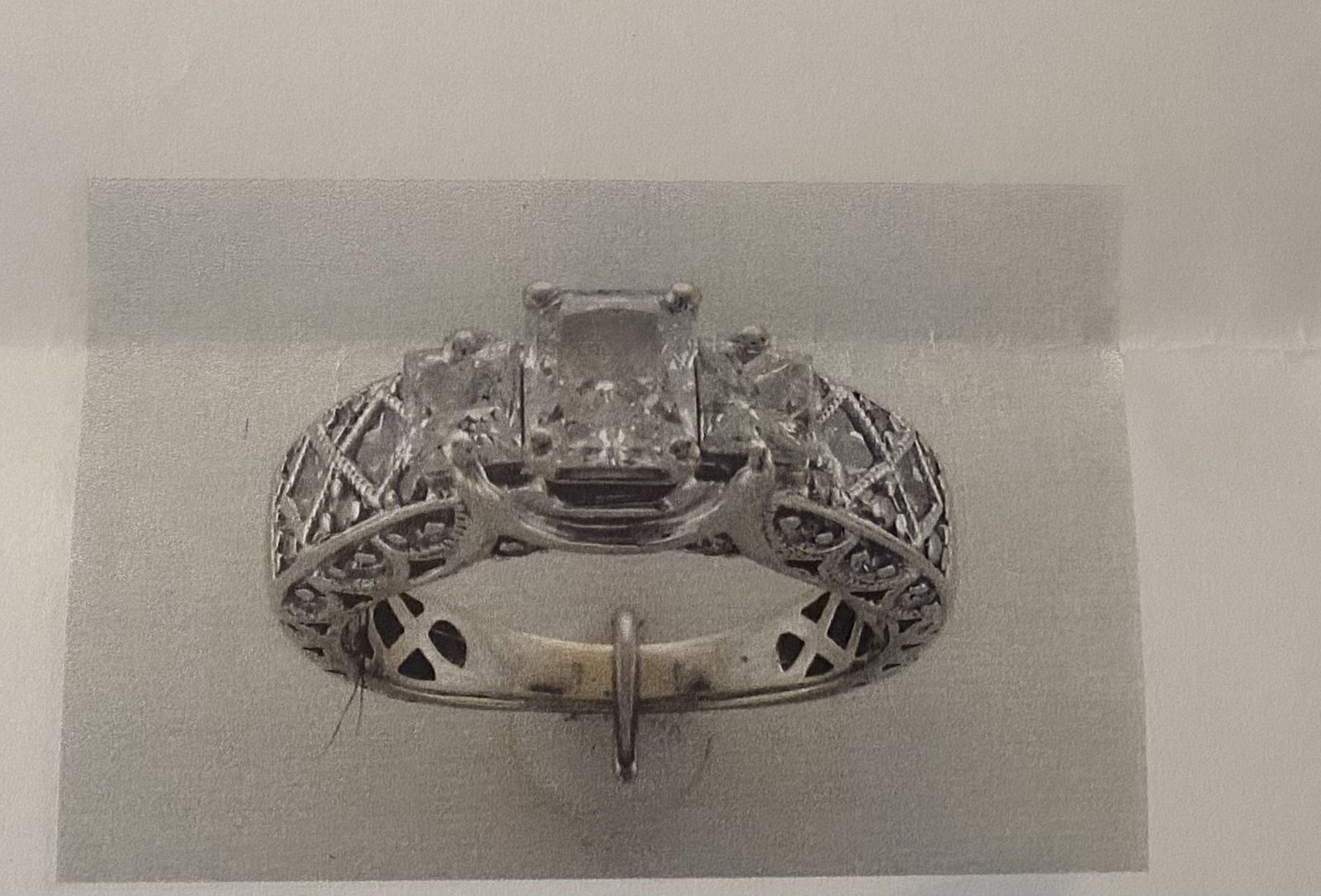 Vintage-inspired three-stone cathedral diamond engagement ring.