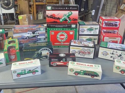 Vintage Sinclair Die-Cast Collectible Toy Vehicles and Airplane Banks in Boxs. Lots of vintage literature and banners and such.