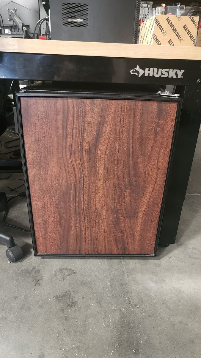 Faux wood–looking mini fridge for sale. Great for an office, bedroom, shop, or garage.
