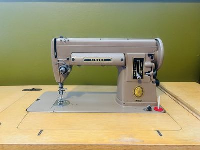 Vintage Singer sewing machine in original cabinet