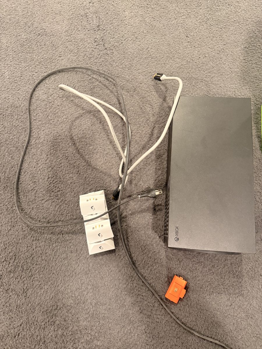 Xbox series x console with cords and games, charging batteries, 2 controllers.