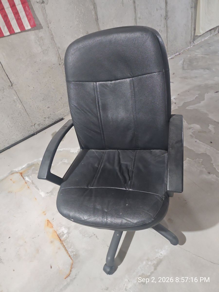 Used black faux-leather high-back rolling office chair