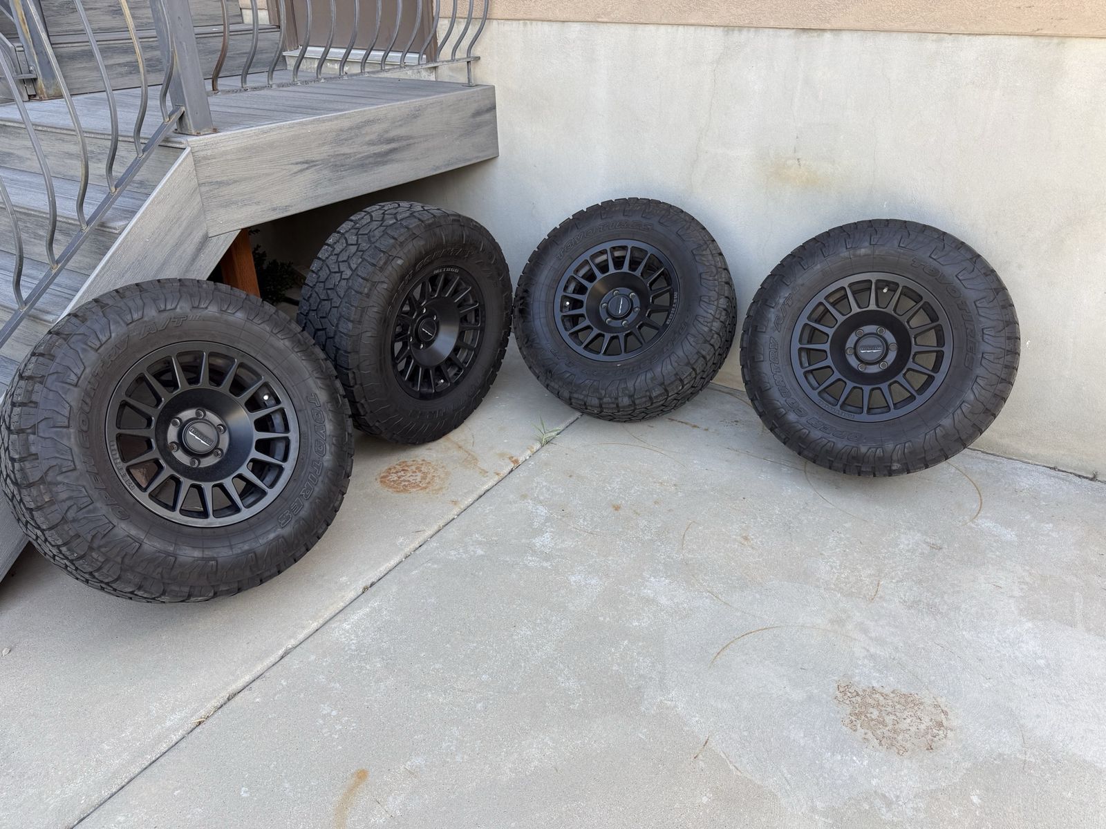 Set of 4 Method Race Wheels with Toyo Open Country A/T III Tires (35x12.50R18LT)