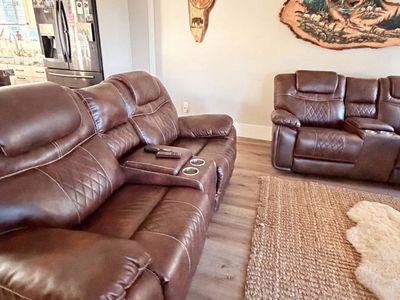 2 Brown Leather Reclining Loveseats with Center Console and Cup Holders