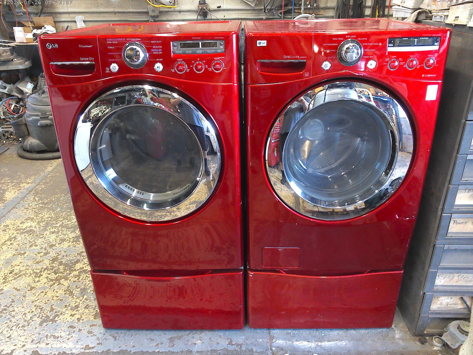 LG front load washer with matched electric dryer on pedestals