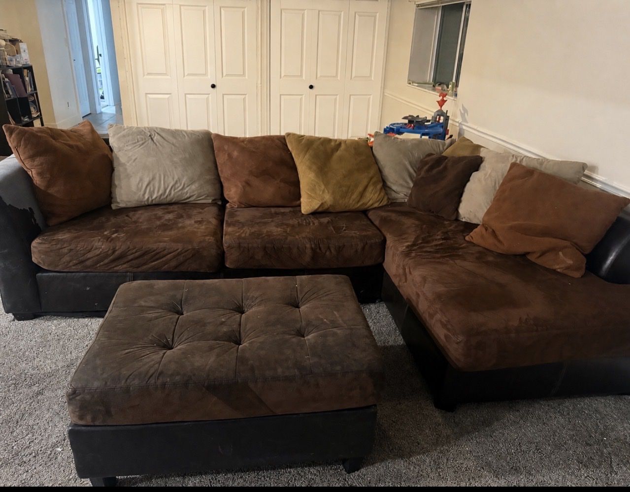 Brown sectional couch with chase and ottoman