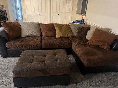 Brown sectional couch with chase and ottoman