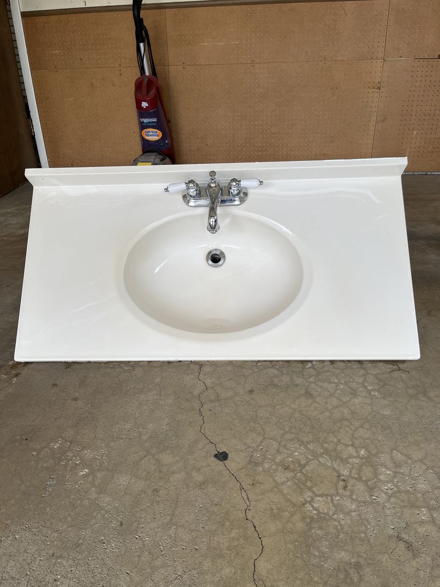 White Vanity Top with Integrated Sink and Chrome Faucet