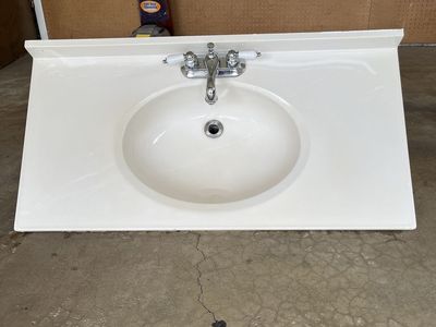 White Vanity Top with Integrated Sink and Chrome Faucet