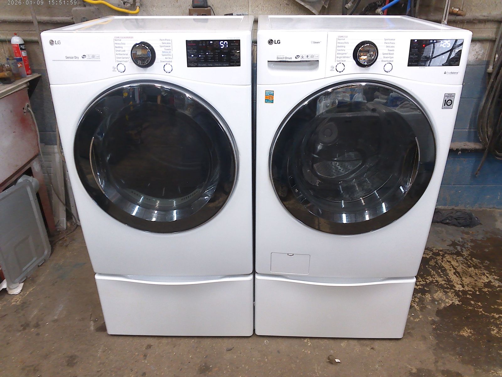 LG front load washer with matched electric dryer on pedestals