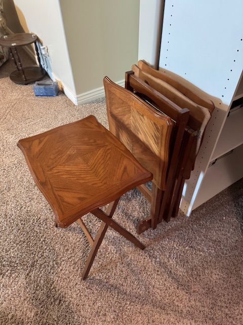 folding wooden TV trays (snack tables)—likely 1970s–1990s oak or oak-veneer sets.