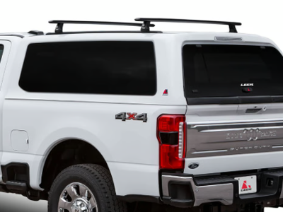 LEER 100XQ Sport Fiberglass Truck Cap with a Thule Tracker roof rack