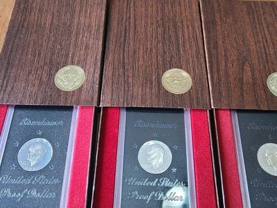 3 Ike brown box proof coins in factory boxes .