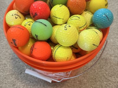 125 colored golf balls in new bucket