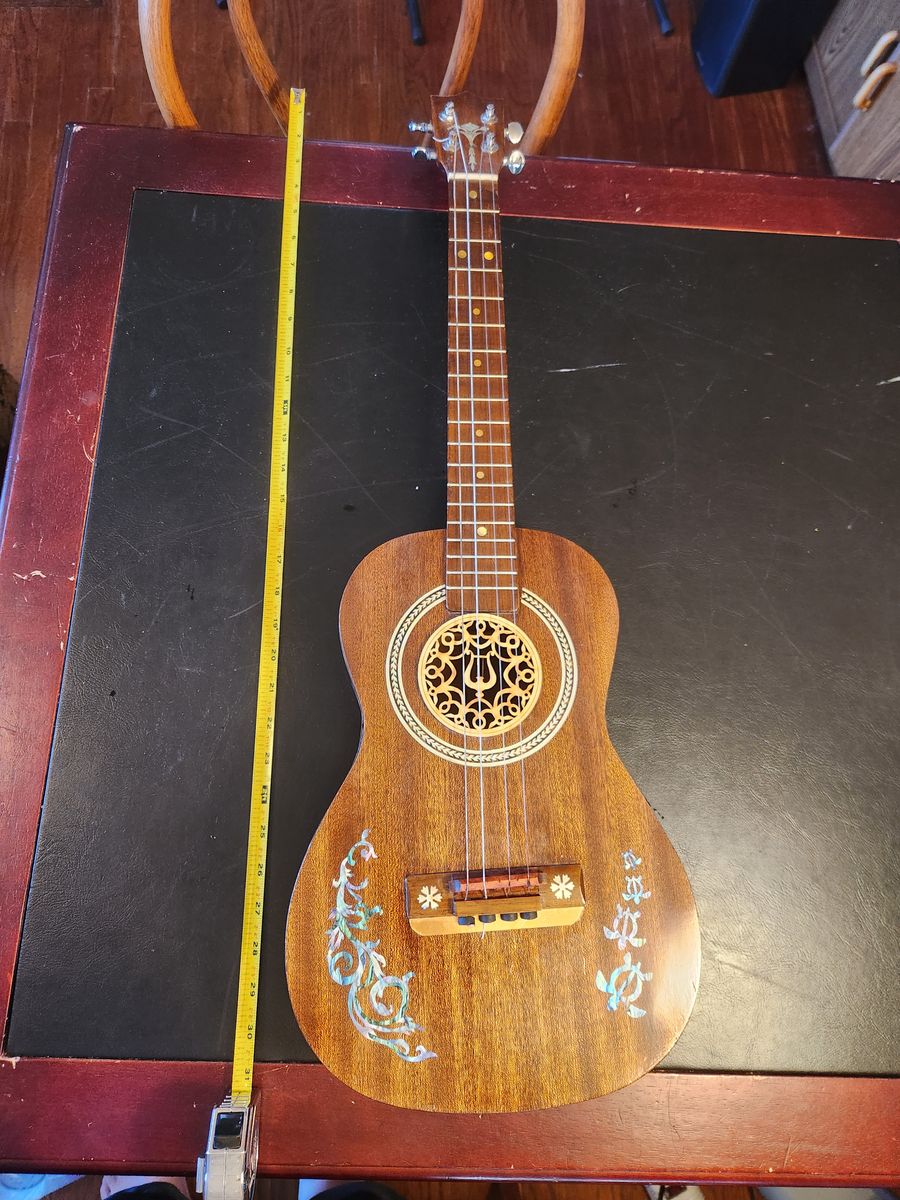 Interesting custom made 31" Baritone Tenor Ukulele.  Has cool details and gorgeous wood.