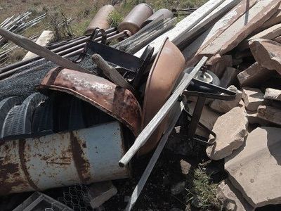 Assorted Scrap Metal, Wheelbarrow Tubs, and Landscaping Stone Pile