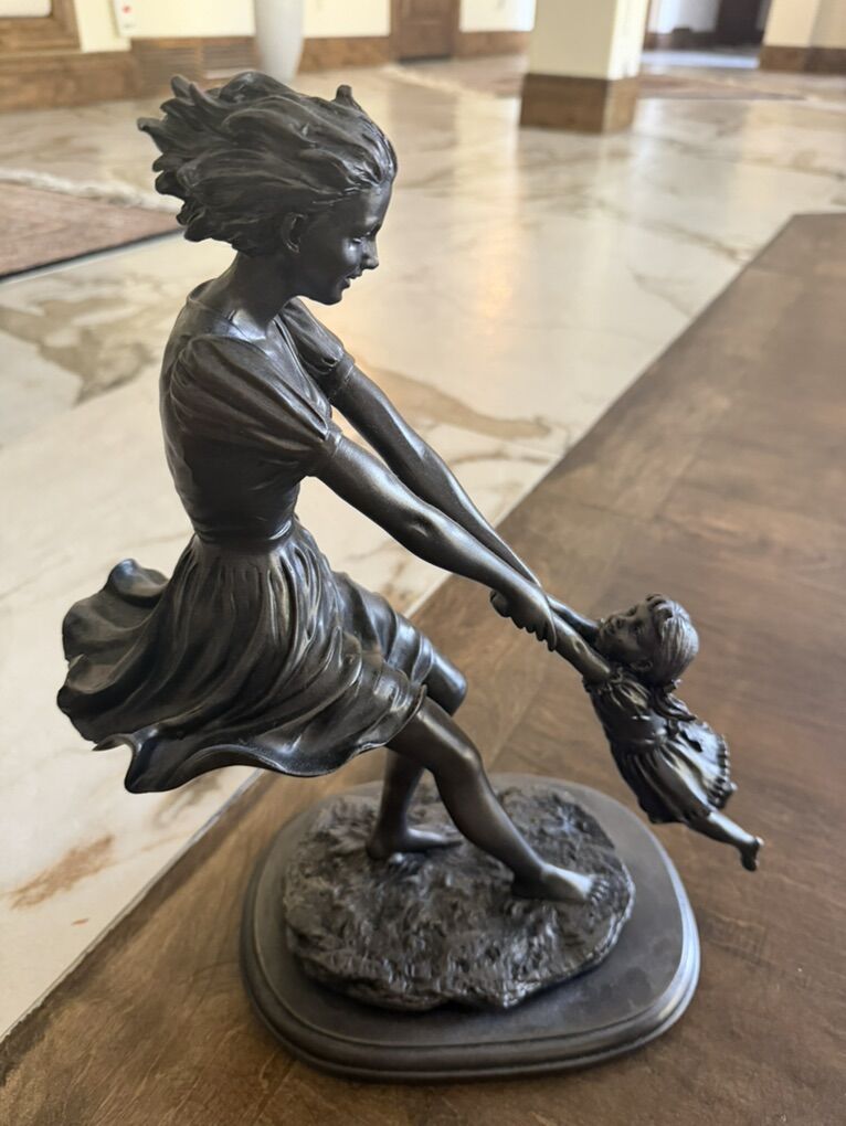Bronze sculpture mother holding her daughter