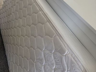 Twin size bed with bed sheet and comforter