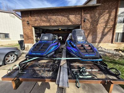 Snowmobiles with tilt deck
